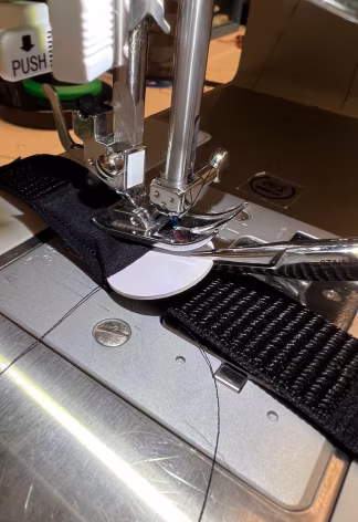 Close-up of the band feeding through the sewing machine