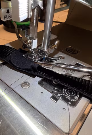 Close-up of the stitched RFID pouch under the machine foot